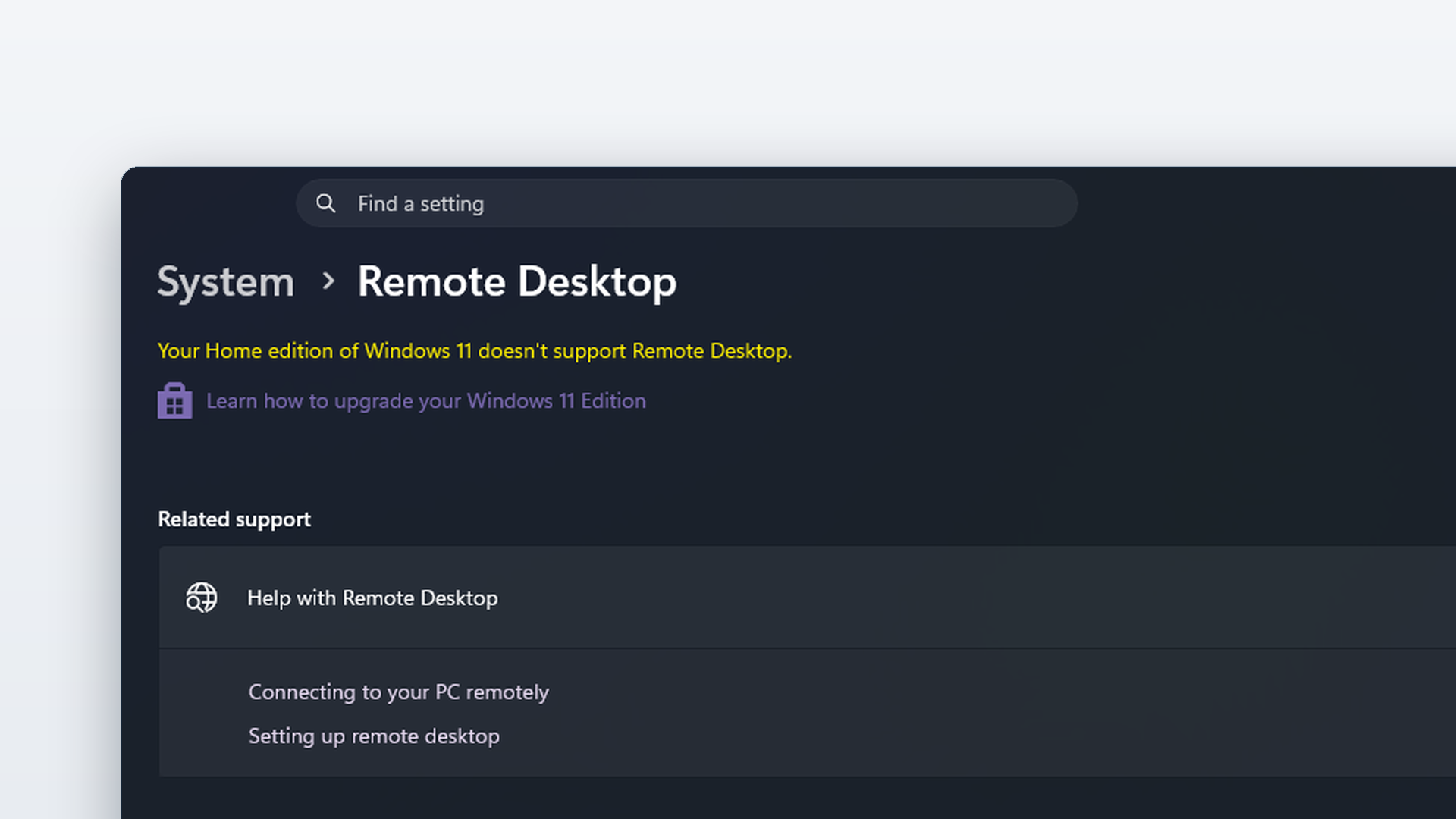 Windows 11 Settings open to System > Remote Desktop, showing the notice "Your Home edition of Windows 11 doesn't support Remote Desktop" and a link to upgrade the Windows edition